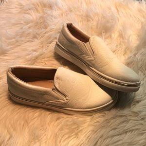 White slip on sneakers with gold rim accent